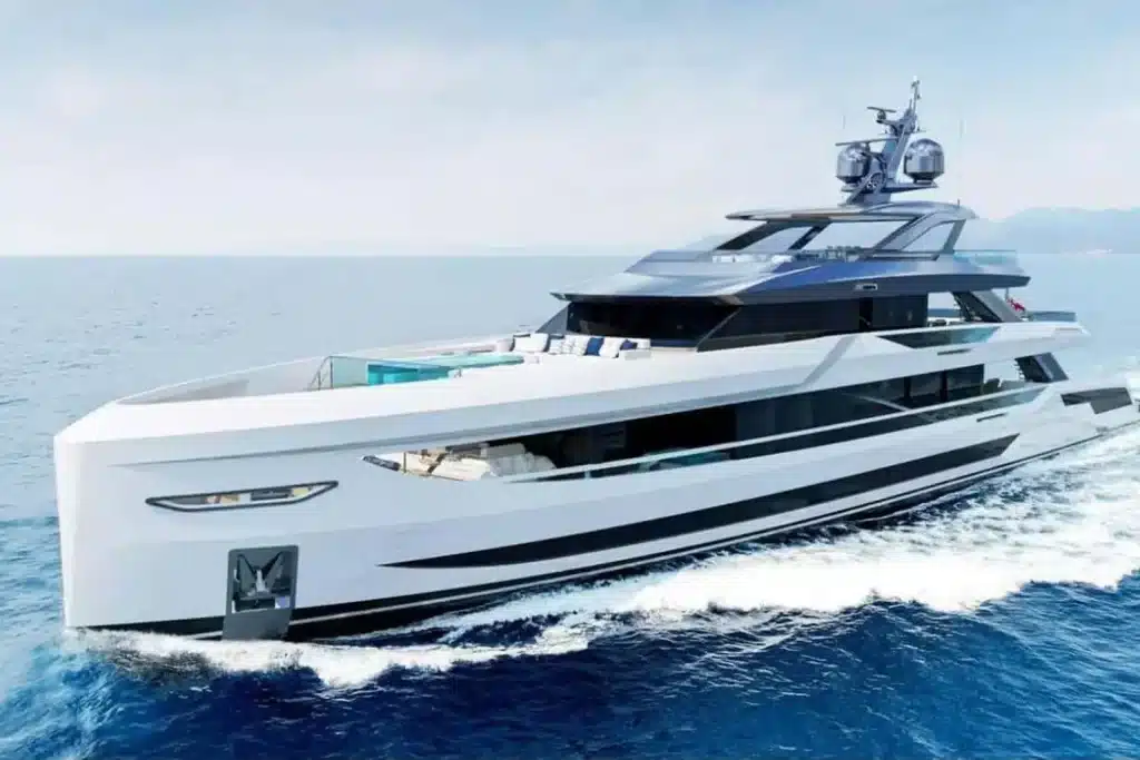 Large white superyacht cruising on turquoise water under a clear sky