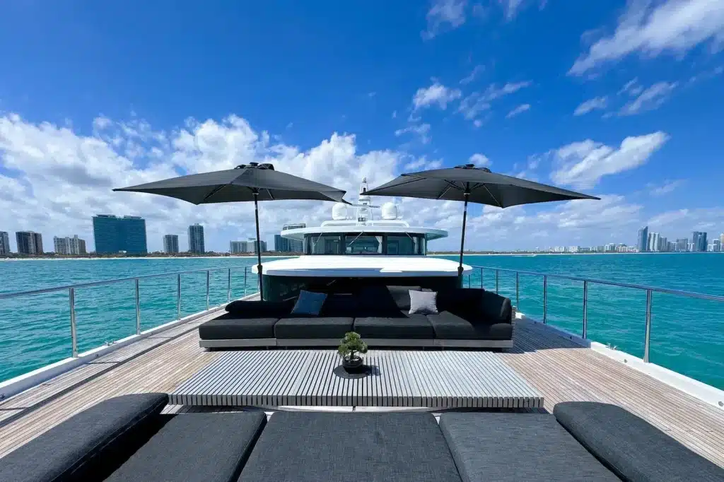 Bow lounge with shade umbrellas on the 112 foot WHS Marine yacht, Miami skyline behind