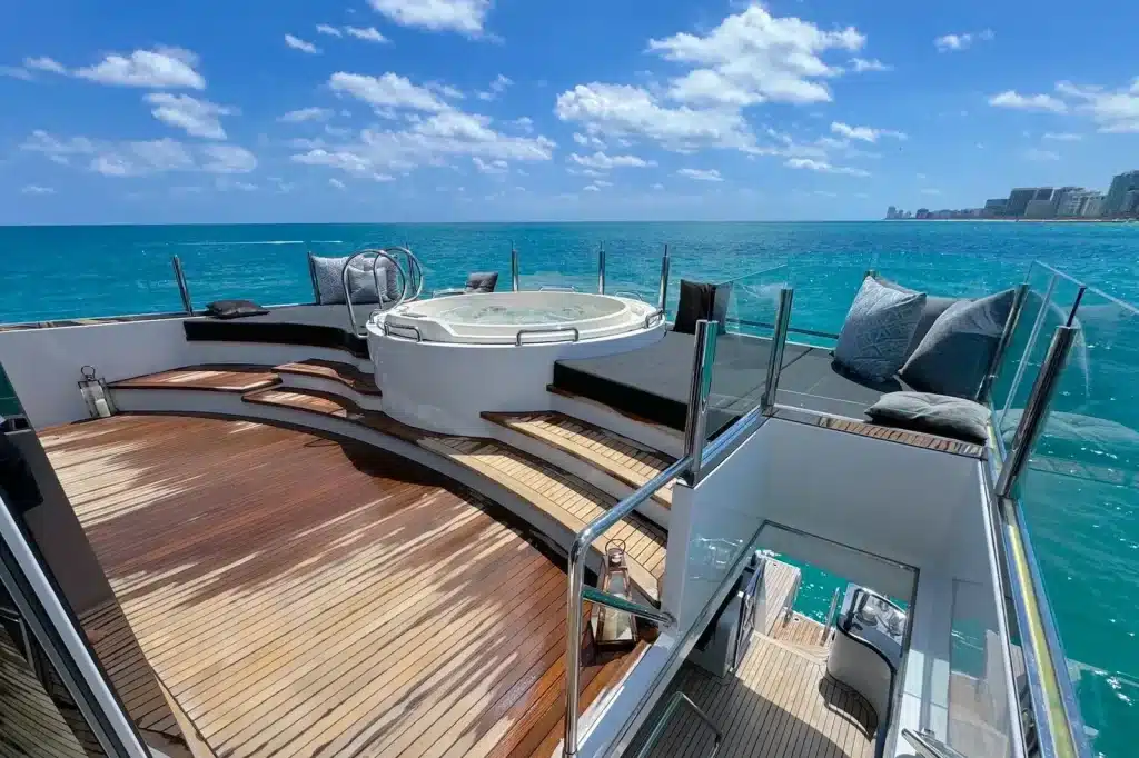 Upper deck hot tub and teak lounge on the 112 foot WHS Marine yacht, Miami Beach skyline on the horizon