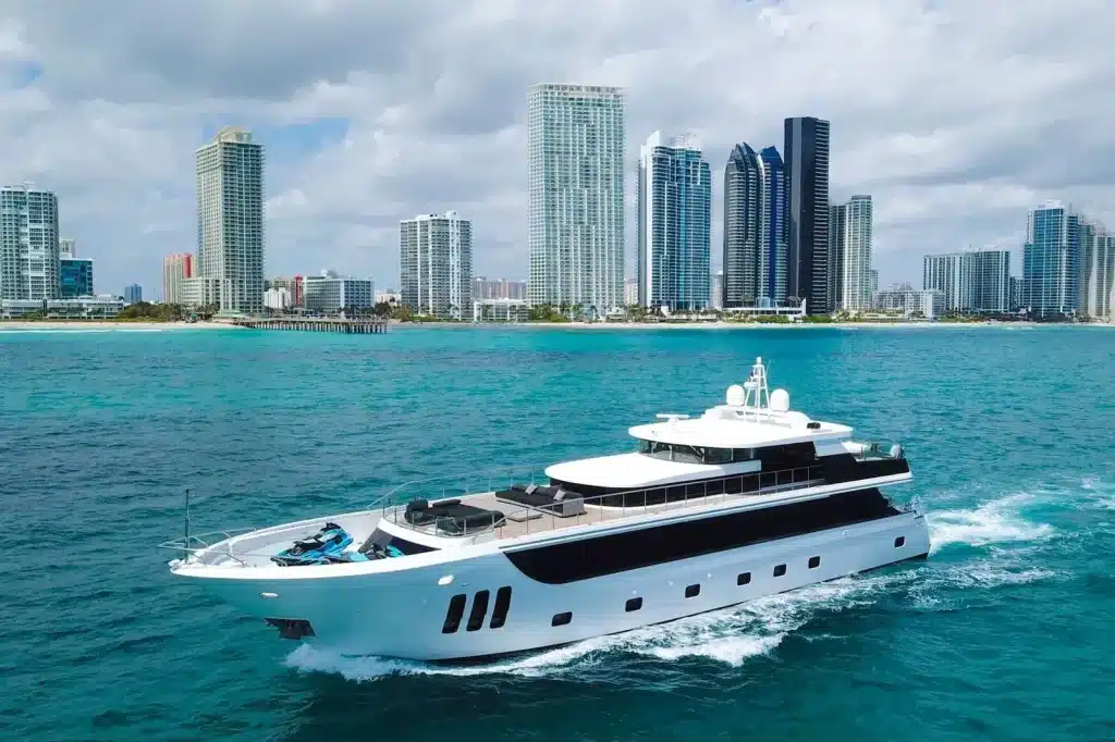 112 foot crewed yacht cruising past the Miami skyline