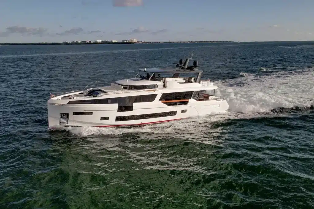 Sleek motor yacht running across calm bay water near Miami